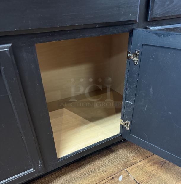 Wooden display/storage cabinet with live edge top, open door, revealing internal compartment. Dark finish, in good condition.