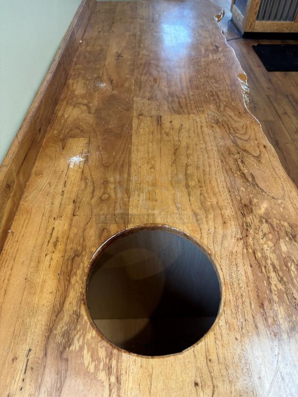 Wooden display/storage cabinet with live edge top, featuring a cutout for trash disposal. Smooth finish, natural wood grain.