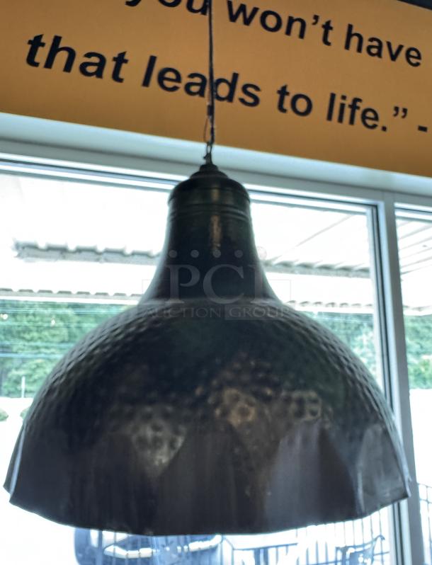 Copper pendant light with a hammered texture, in good condition, hanging in a window-lit setting.