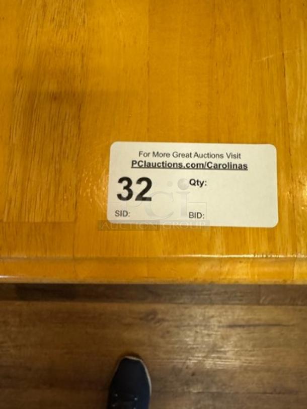 Wooden dining table, natural finish, in good condition. Auction label shows "32". Visit PCIAuctions.com/Carolinas for more.