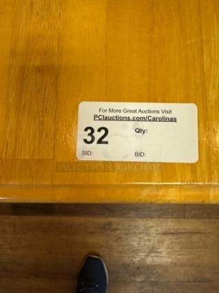 Wooden dining table, natural finish, in good condition. Auction label shows "32". Visit PCIAuctions.com/Carolinas for more.