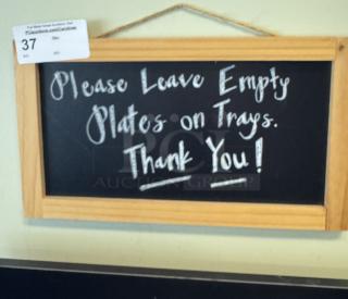 Wood-framed chalkboard sign with hanging rope, reads "Please Leave Empty Plates on Trays. Thank You!" Auction tag "37" attached.