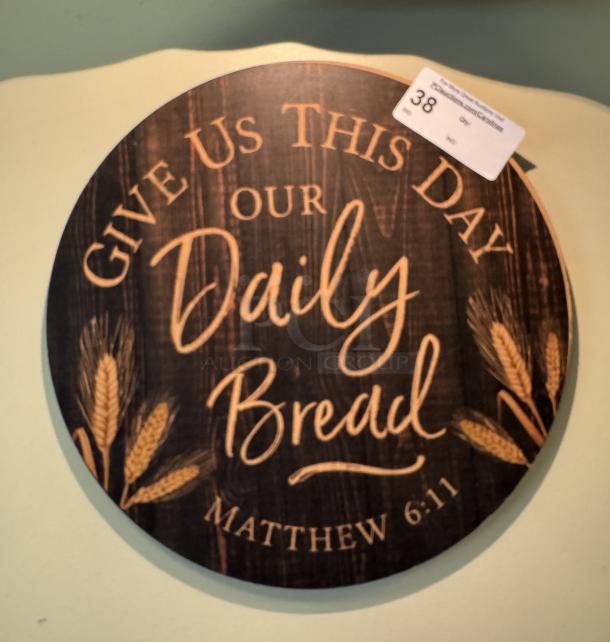 Round wooden picture with "Give Us This Day Our Daily Bread" text and wheat design, featuring Matthew 6:11 verse.