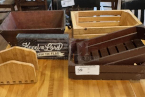 Assorted wooden display boxes and baskets on table, featuring rustic designs and varying wood tones, ideal for home decor.