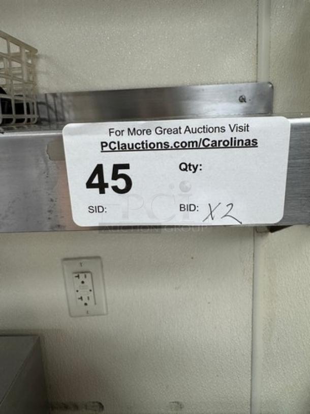 Stainless steel shelving unit, visible auction tag showing bid for 2 units, item SID 45.