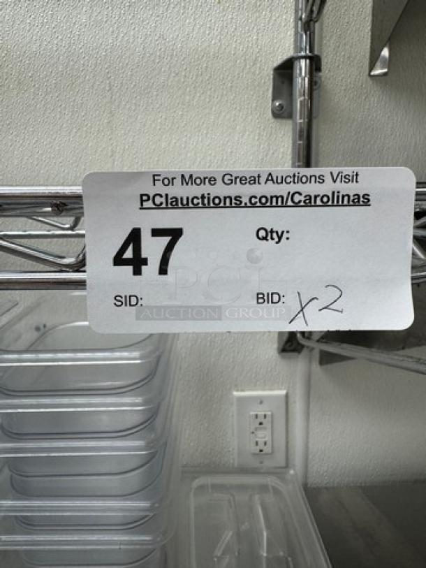 Stainless wire shelving with visible auction label showing lot number 47 and quantity of two.