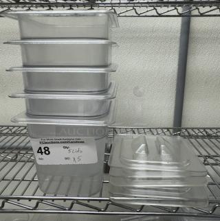 Vigor stainless steel 1/6 x 6 pans with lids, set of 5. Pans and lids stacked on a metal shelf. Auction tag reads "Qty: 5 Lids x 5."