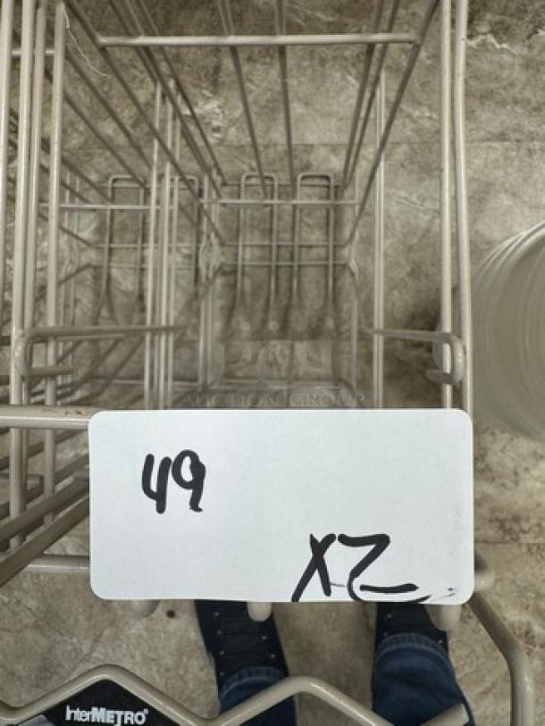 Intermetro metal racks, 2 units, durable wire construction, visible tag marked "49 XZ," suitable for storage and organization.