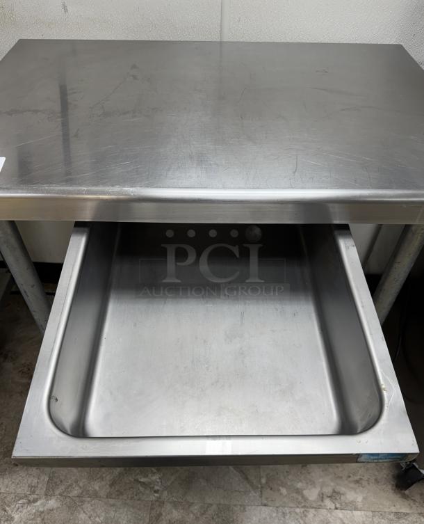 Equipment stand with drawer and galvanized shelf on casters, stainless steel, good condition, features a spacious work surface.