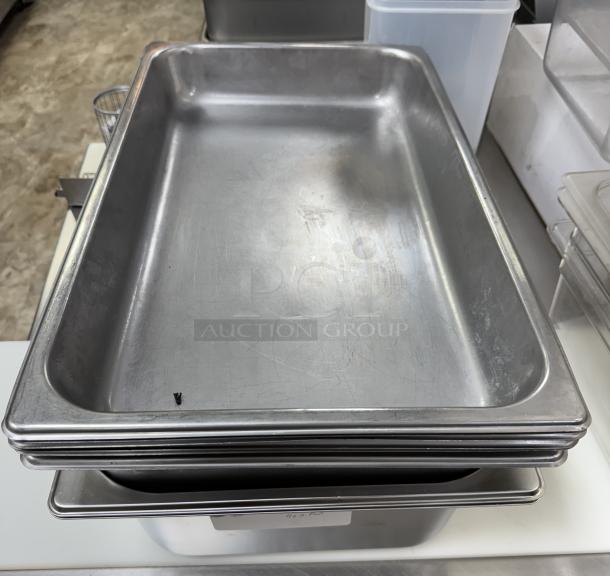 Full-size stainless pans set: 4 pans 2" deep, 2 pans 4" deep, 2 pans 6" deep. Good condition, stackable design.