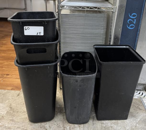 Set of five black plastic trash cans, rectangular, moderate wear, labeled "60 x5." Suitable for commercial use.