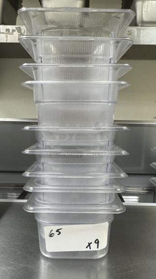Stack of 9 Vollrath acrylic containers, 1/6 size, 4 inches deep, labeled "65 x9," in good condition.