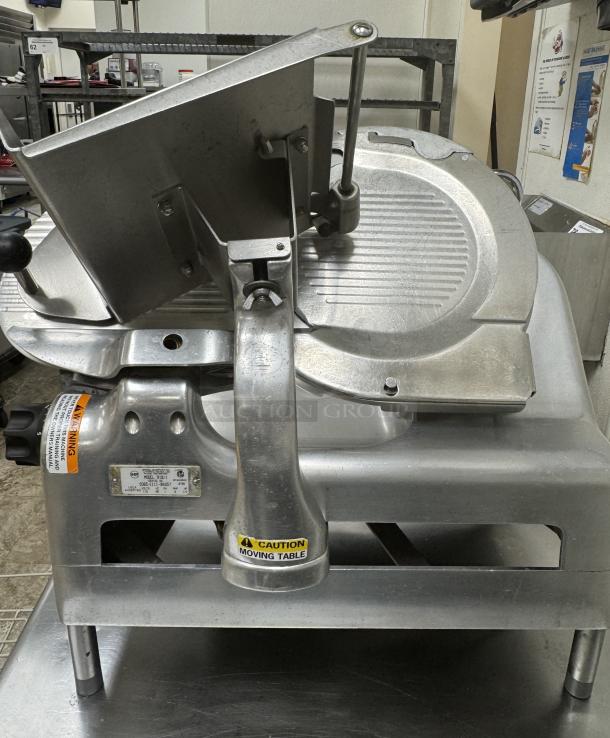 Berkel Model 919/1 slicer in stainless steel, tested and working, 115V, 1 phase. Features caution label for moving table.