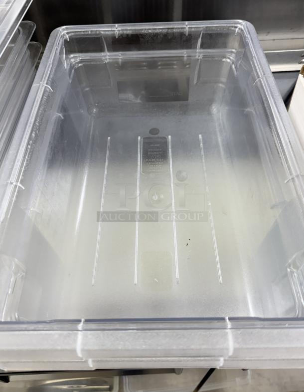 Carlisle plastic container with lid, clear, visible wear, commercial-grade, 2-inch depth, marked with model details.