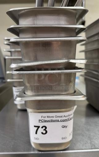 Stainless steel 1/6 x 4 pans with three lids, stacked. Includes auction label showing number 73. 
