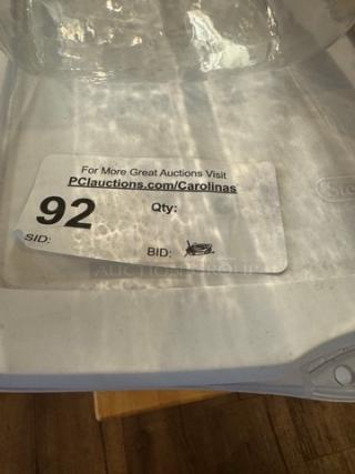 Assorted storage containers with lid, featuring auction label number 92. Clear and white plastic, good condition.