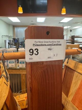 Wooden basket floor display with multiple tiers. Label indicates auction lot number 93. Sturdy condition, ideal for retail use.