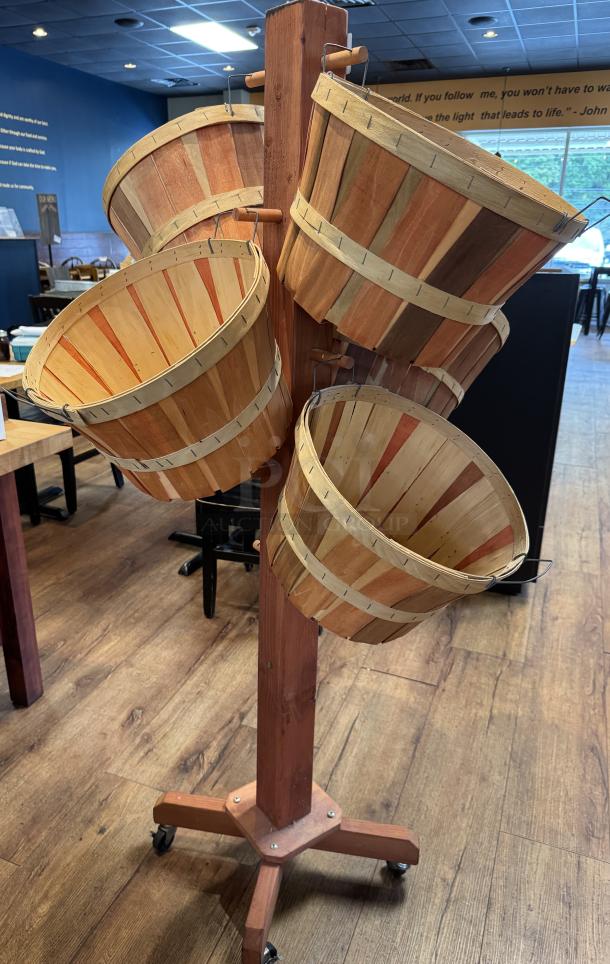 Wooden basket floor display with six slat-constructed baskets on a wheeled stand. Ideal for retail use.