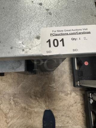 Metal-top and wood tables with visible wear, sizes 36x24x32 and 18x17x23. Auction lot label indicates quantity of 2.