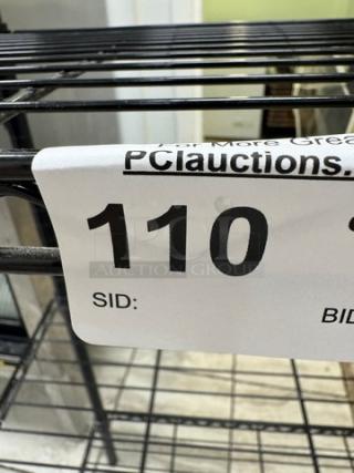 Four-shelf wire rack, sturdy metal construction, good condition, auction number 110 tag visible.