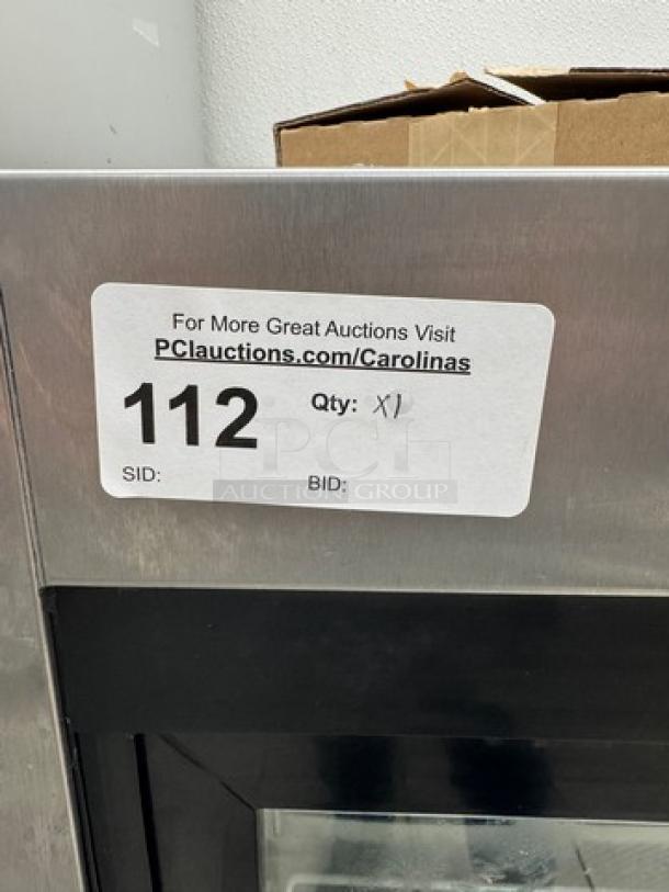 True Refrigerated Display Case TSD-09G-LD, stainless steel, tested and working, auction tag labeled "112", visit PCauctions.com/Carolinas.