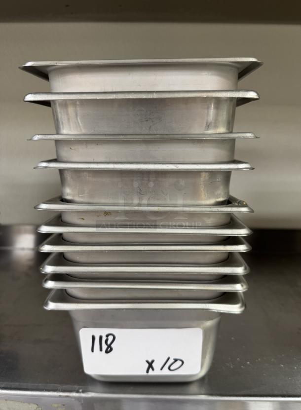 Stack of 10 stainless steel 1/6 x 4 pans, lightly used, labeled "118 x10," ideal for commercial kitchens.