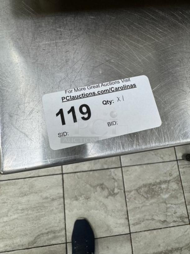 Stainless steel table with undershelf, light wear. Auction label: "119, Qty: X1." Ideal for kitchen or workspace.