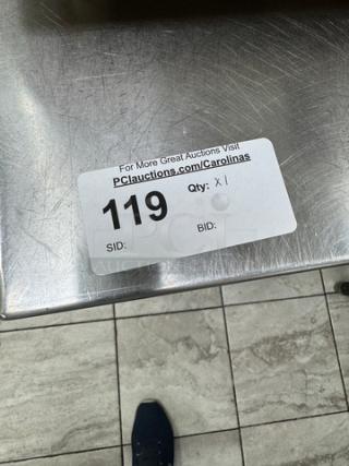 Stainless steel table with undershelf, light wear. Auction label: "119, Qty: X1." Ideal for kitchen or workspace.