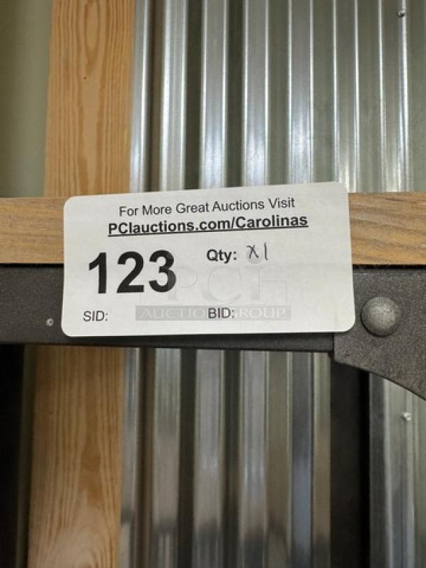Metal and wood rack with 4 shelves, item 123, in good condition. Auction label directs to PCAuctions.com/Carolinas.
