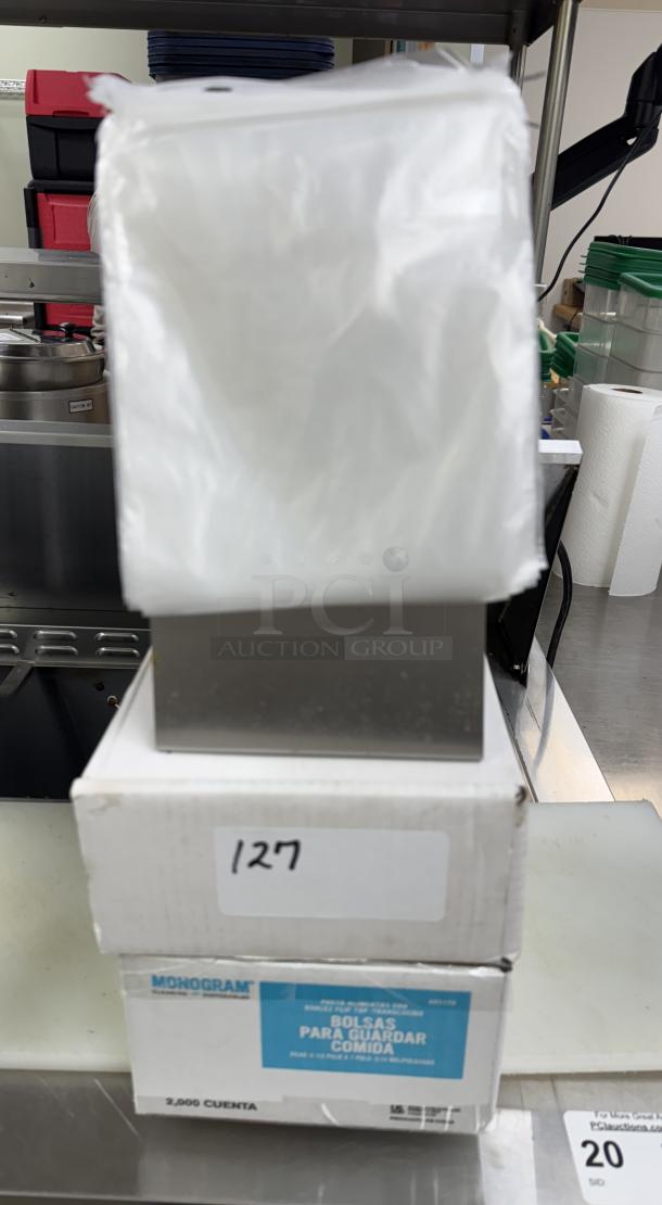 Monogram sealable portion bags with metal holder. Box marked "2,000 count" and number "127." New condition.