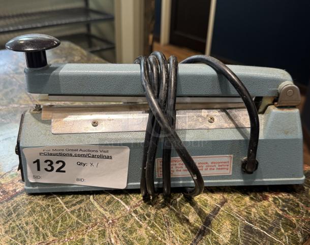 Upline 8" Impulse Sealer, Model H163, lightly used. Features intact labeling, cord wrap, and auction tag #132.