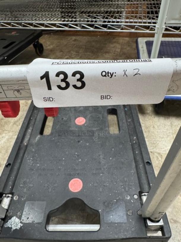 Rolling folding platform truck, black, with red locking mechanism. Good condition, auction lot number 133, quantity 2.