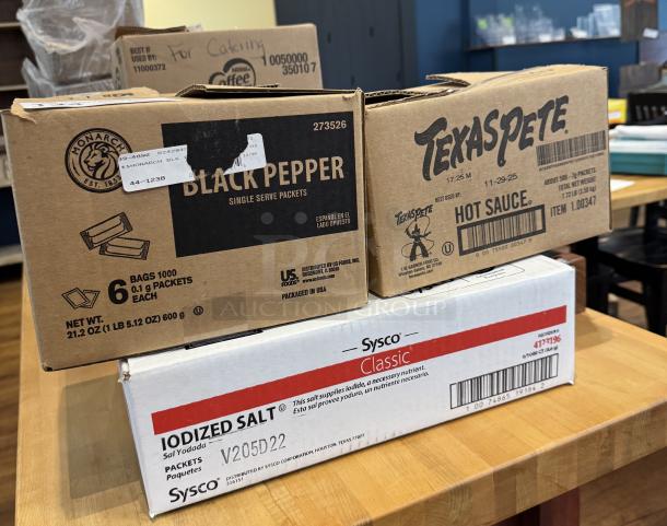 Boxes labeled "Monarch Black Pepper," "Texas Pete Hot Sauce," and "Sysco Iodized Salt." Partial contents visible.