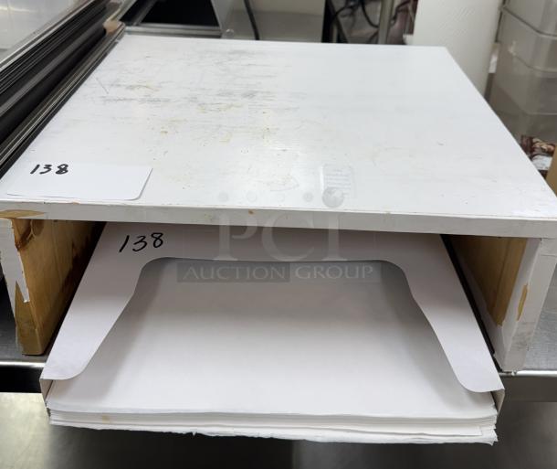 Wooden stand with box of wax paper, showing shelf design. Item number 138 visible. Signs of wear on surface.