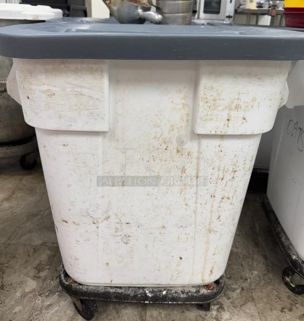 Rubbermaid rolling dry goods storage container, white, with blue lid, visible wear, on wheels, used condition.