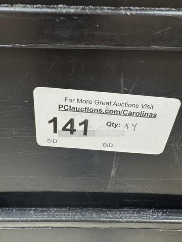 Rubbermaid 23 Gal. containers set of 4. Visible auction tag with lot number 141. Black durable material.