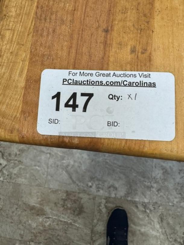 Large butcher block top table with sturdy galvanized legs, visible auction label reads "147," indicating item listing.