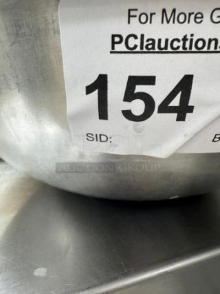 Stainless mixing bowl with auction tag number 154, showing side detail. Part of a set of three.
