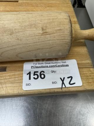 Wooden cutting board with 24" rolling pin. Auction tag shows item 156. Lightly used condition, natural wood finish.