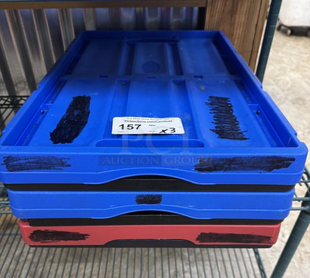 Clever Made collapsible storage containers, set of 4, stacked. Blue and red with visible black markings and auction label.