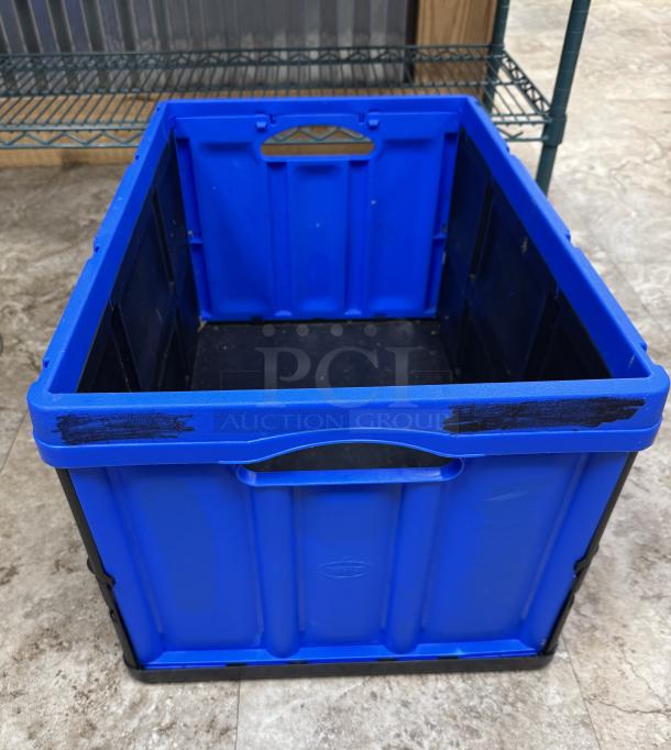 Clever Made collapsible storage container, blue, robust construction, integrated handles, visible wear, versatile storage solution.