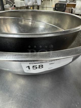 Stainless steel mixing bowls, set of four. Visible auction tag, lot number 158. Sturdy design, suitable for kitchen use.