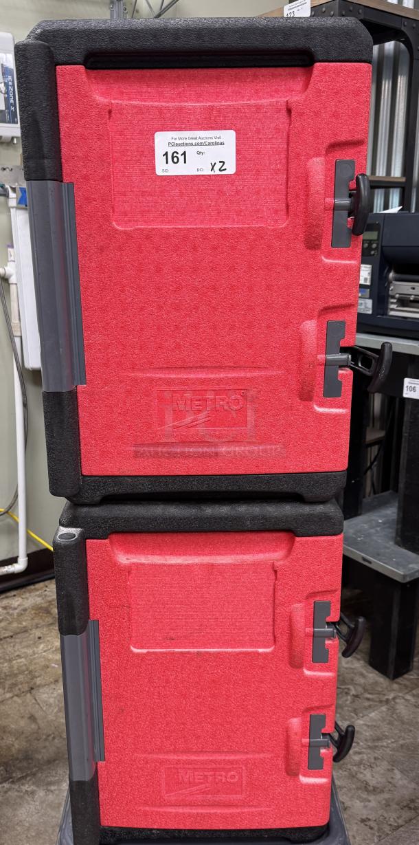 Red Metro warming box on dollie, visible brand label "Metro," dual doors, sturdy condition, auction lot 161 x2.