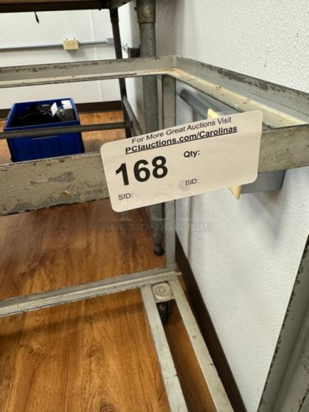 Rolling full-size sheet pan cart, metal frame, sturdy build, visible wear, auction tag 168 attached, ideal for commercial use.