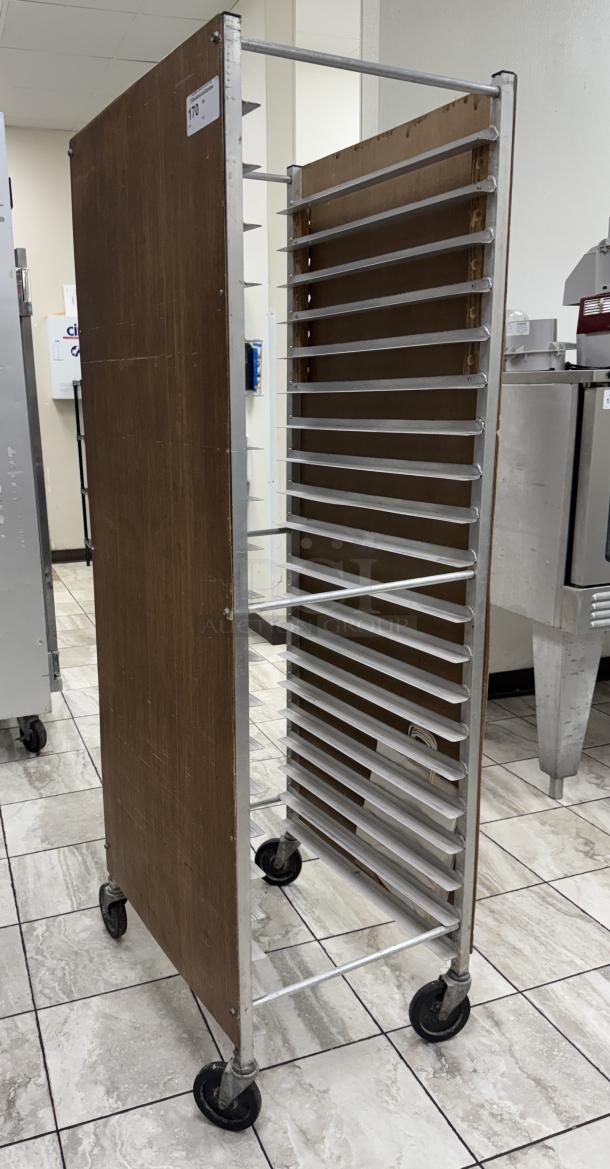 Rolling sheet pan rack with wooden side panels and metal rack slots, equipped with four caster wheels for mobility.