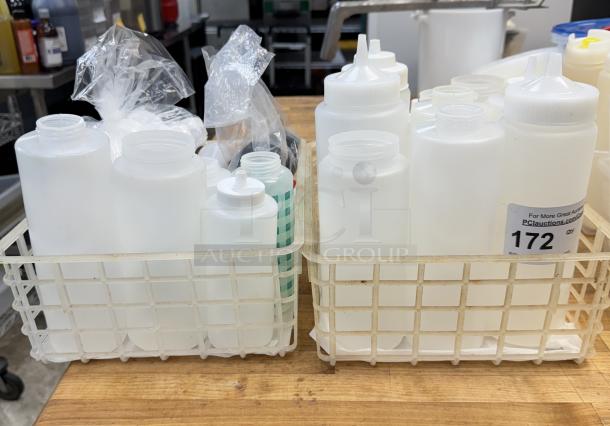 Assorted condiment dispensers and lids in two baskets, various sizes, new condition, auction tag reading "172".