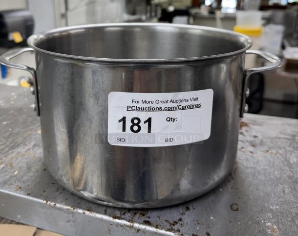 Stainless steel stock pot with sturdy handles, auction tag 181 visible. Ideal for large batch cooking. Good condition.