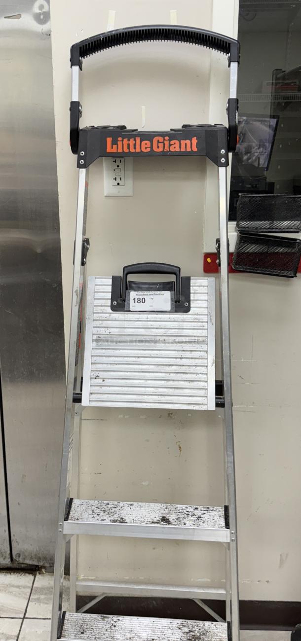 Little Giant ladder/step stool, holds up to 375 lbs, aluminum, foldable design, some wear visible, Item 180 tag attached.