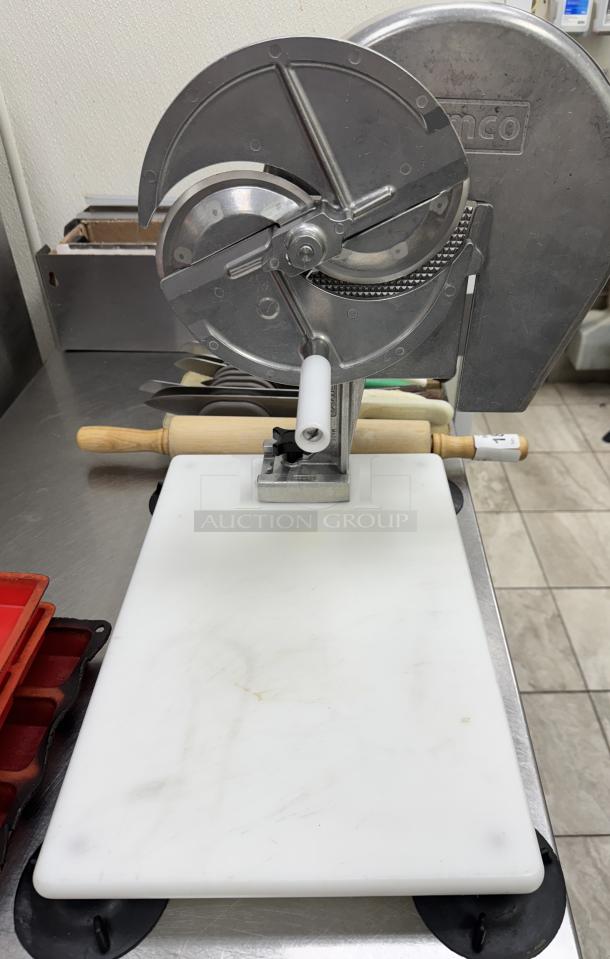 Nemco slicer with cutting board, stainless steel, used condition, includes rolling pin. Ideal for kitchen prep.