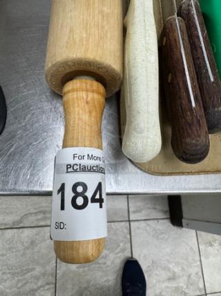 Wooden rolling pin with label, 21 inches long, alongside knife holder containing 8 assorted knives with wooden handles.